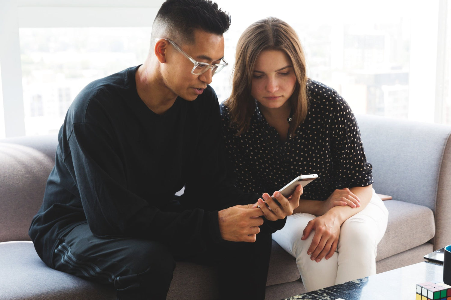 coworkers-looking-at-mobile-device